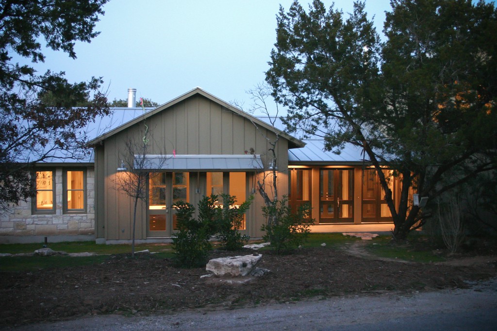 Front view of rustic modern house with a close connection to the natural Texas landscape.