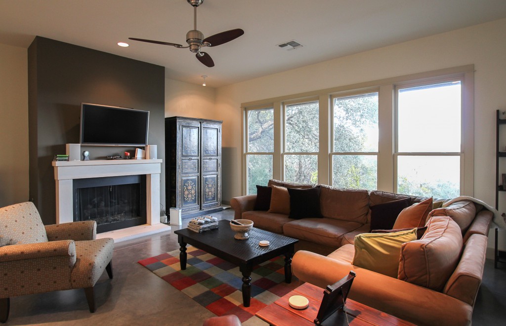 Furnished living area centers around a limestone fireplace. 