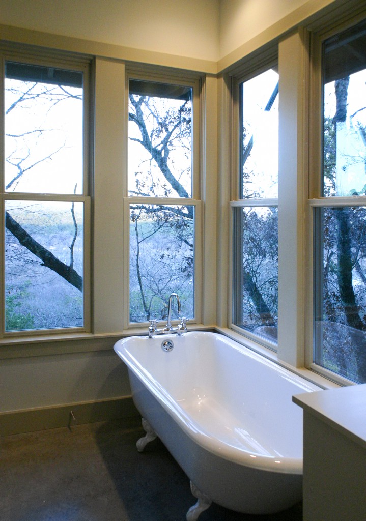 Clawfoot bathtub in master bath. Windows overlook distant view.