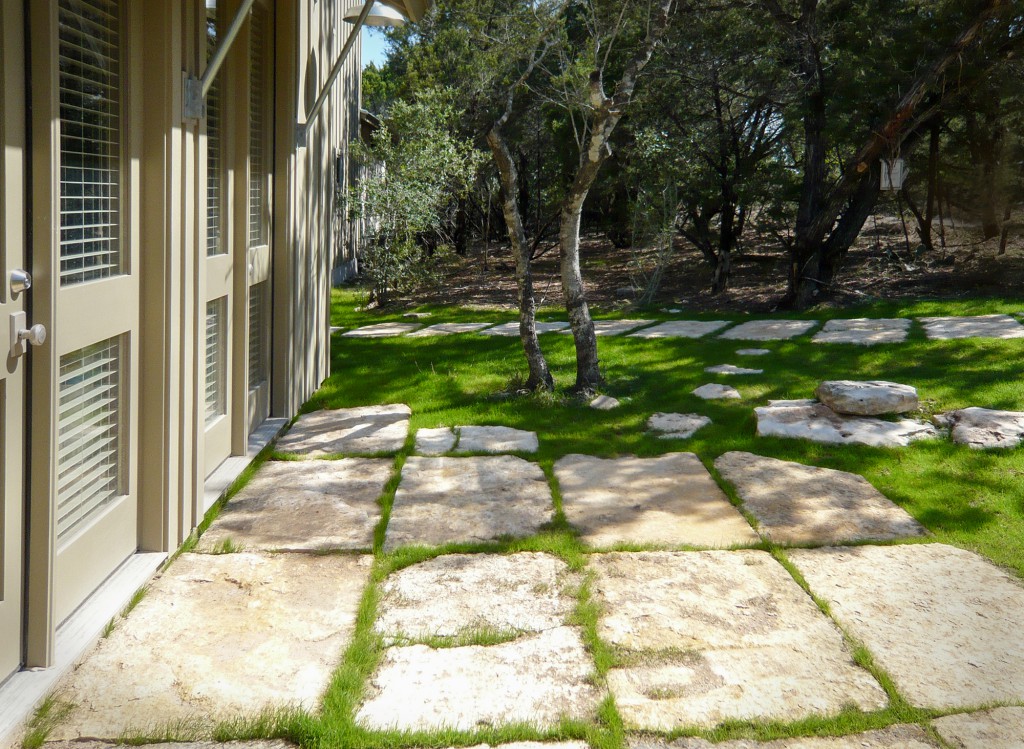 Rustic patio off kitchen is made with limestone blocks. 
