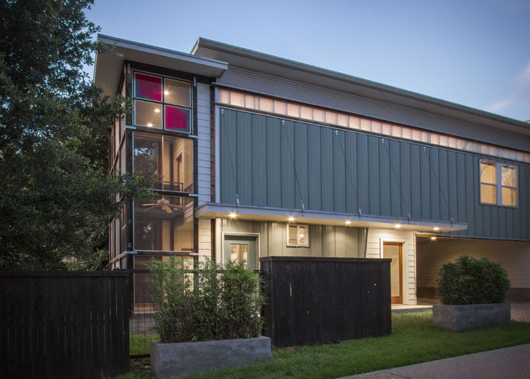 Modern style condominium in north central Austin. Shows front view at evening.