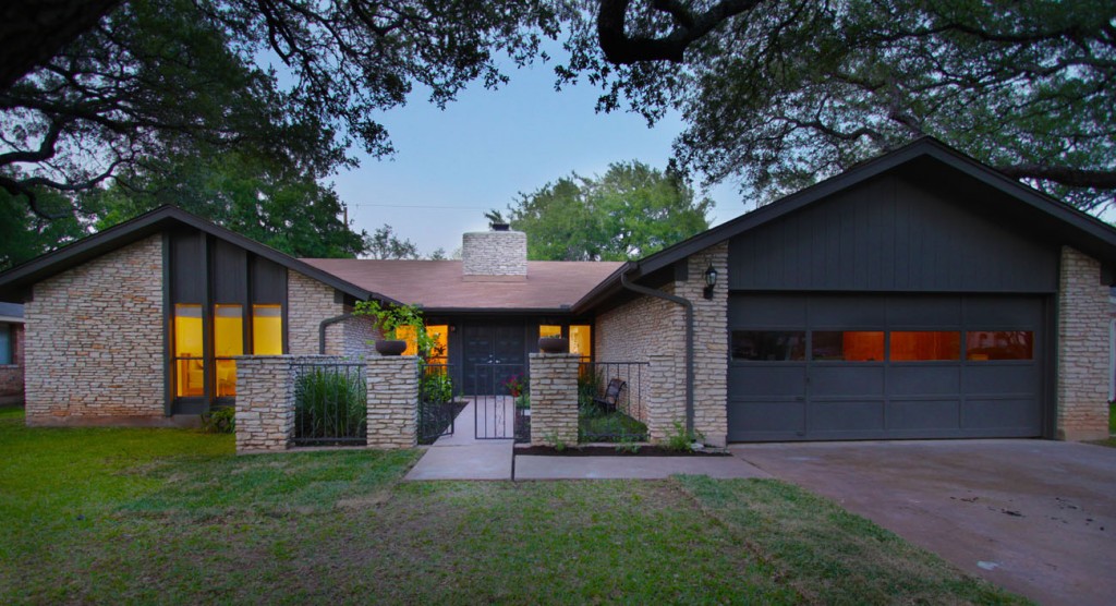Front view of home at dusk. Deeply remodeled home in Northwest Austin. 