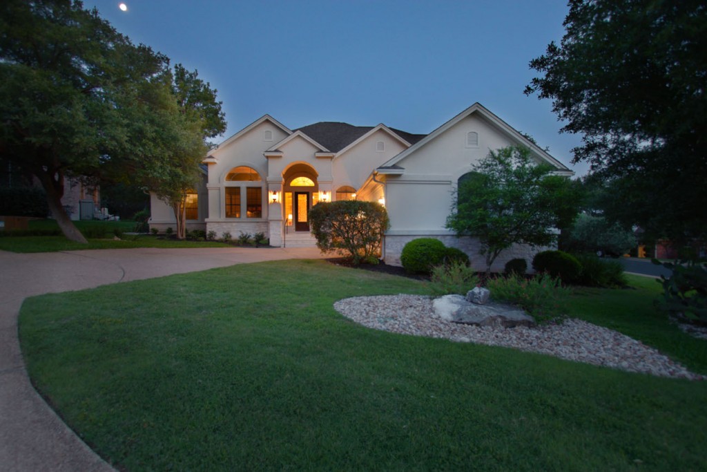 Front view of home at evening on manicured lot in Jester neighborhood.