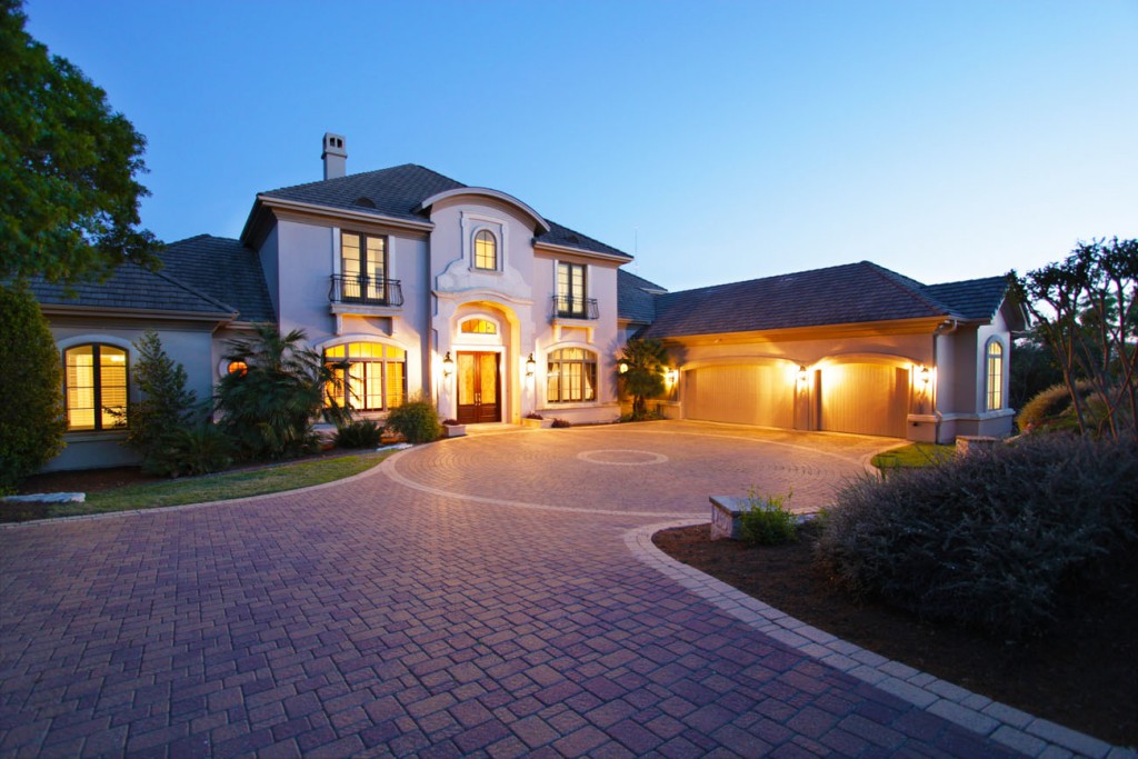 Front view of home at evening. Elegant estate home in Seven Oaks neighborhood. Eanes ISD. 