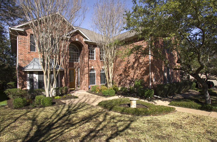 Senna Hills Home in Eanes ISD Westlake area. Red brick traditional on well kept lot.