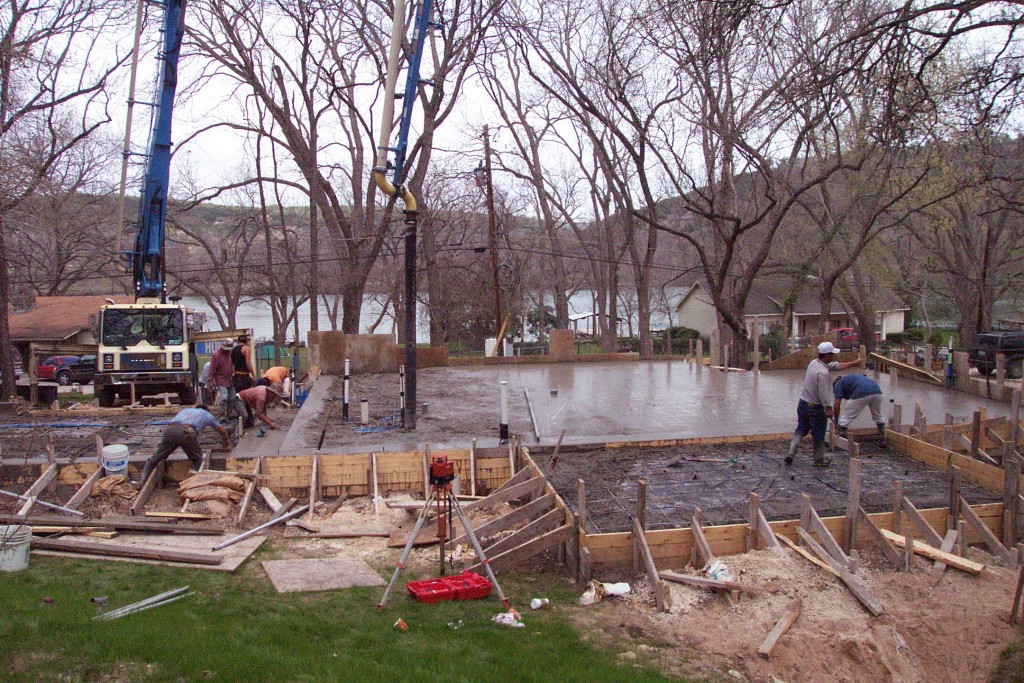 Concrete crew pouring concrete for new foundation. 