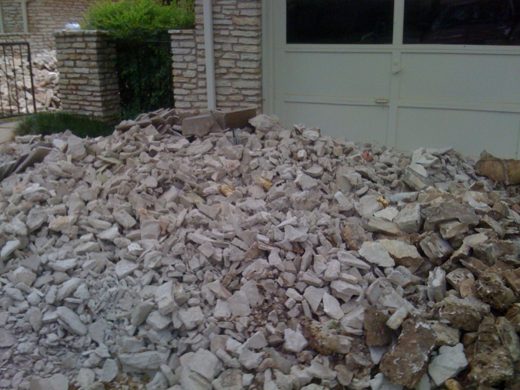 Traditional ranch redo demolition. View of huge pile of stone rubble.