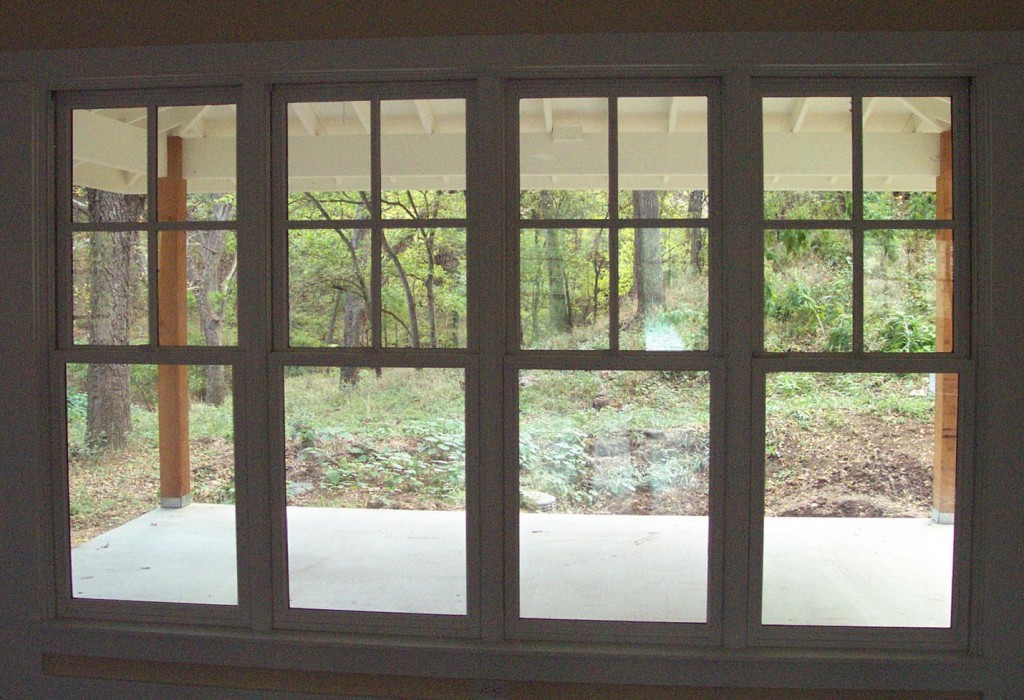 Wood windows with 4 lites over single lite. 