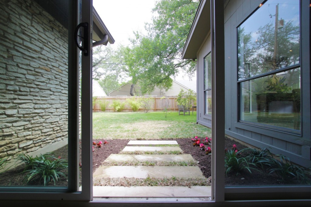 View of improved garden area outside sliding glass door.