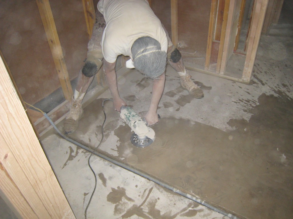 Grinding down concrete floor - a muddy job.  