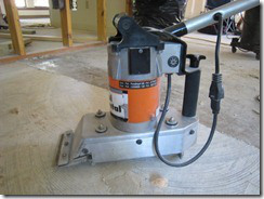 Concrete floor grinder scraping floor to remove glue.
