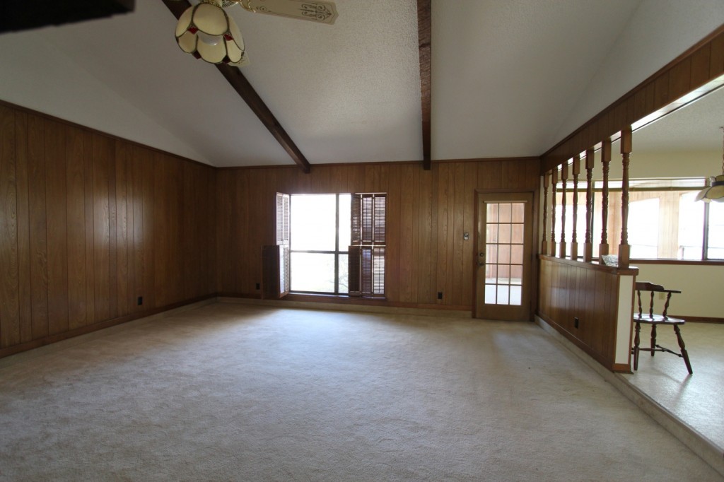 Original living room with single window to outdoors. Dark space.