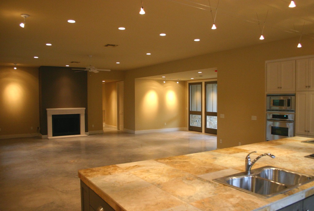 View of living and fireplace. Open plan combines kitchen with living and dining.