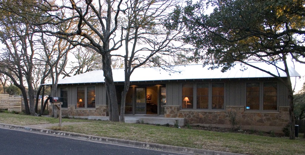 Modern ranch style exterior with metal roof and one story design.