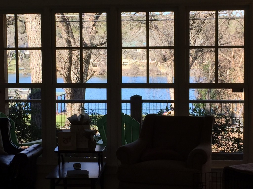 Lake view from living room windows in modern Craftsman style house on Lake Austin.