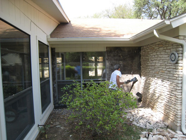 Removal of stone from the exterior wall. Load bearing wall removal Austin. 