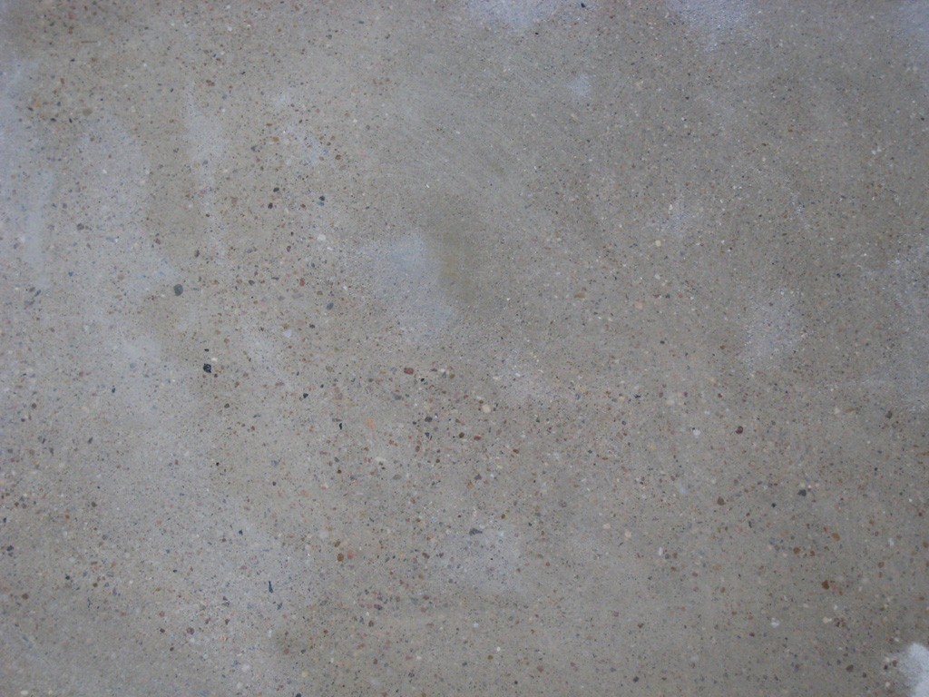 Close up view of clean concrete floor showing exposed pebbles.