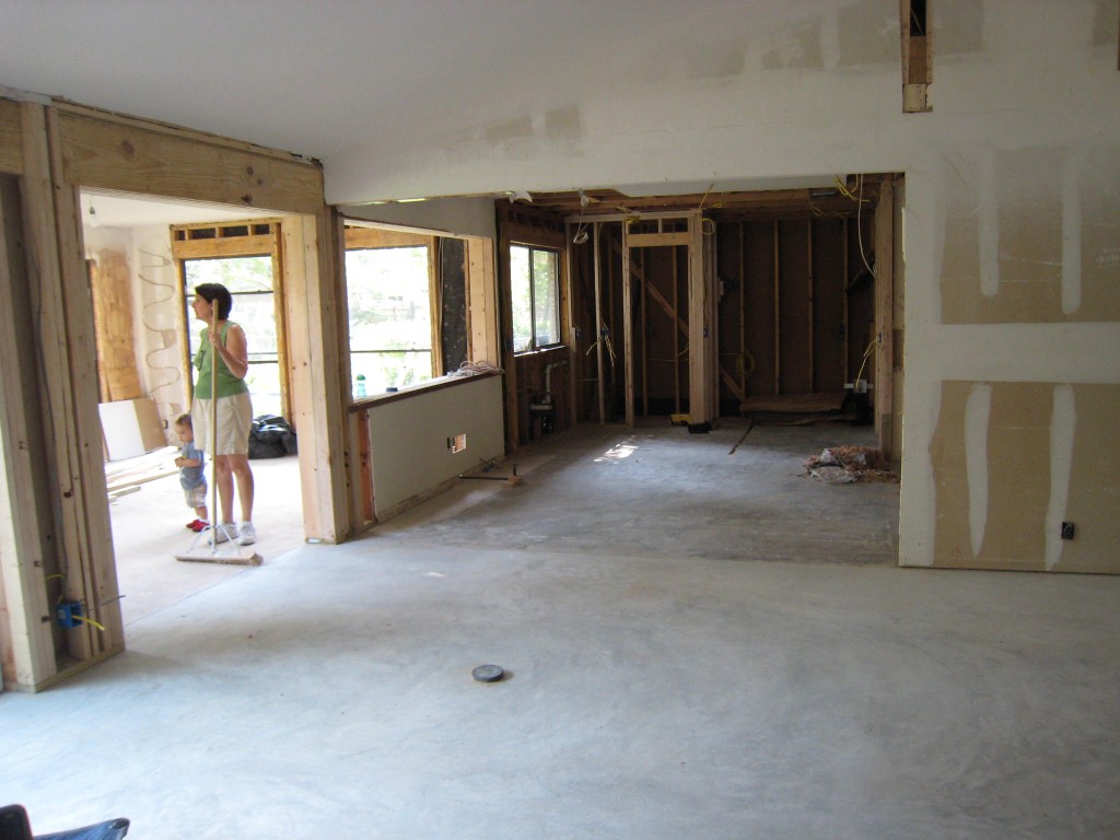 View of new concrete floor poured over the entry and living spaces. 