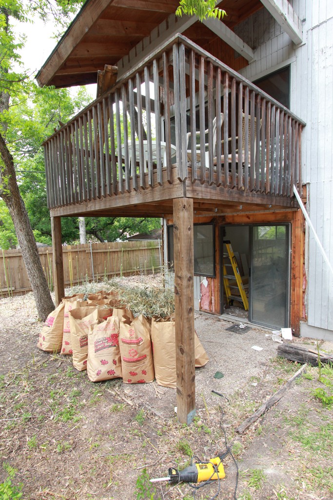 view of rear of house with bags of bamboo leaves.