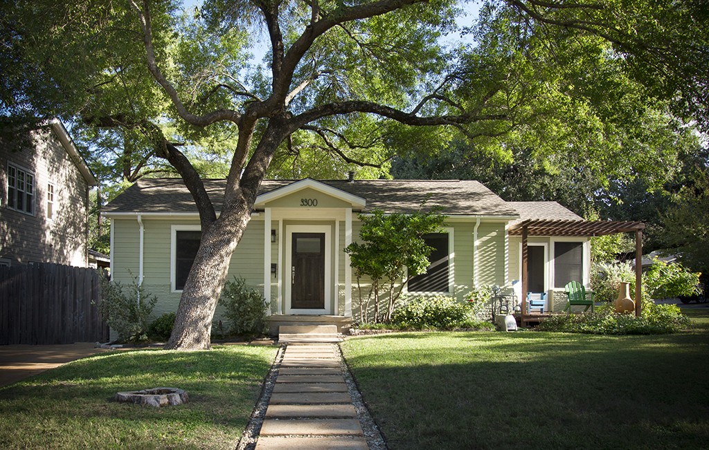 Austin home exteriors - Central Austin bungalow under large trees.