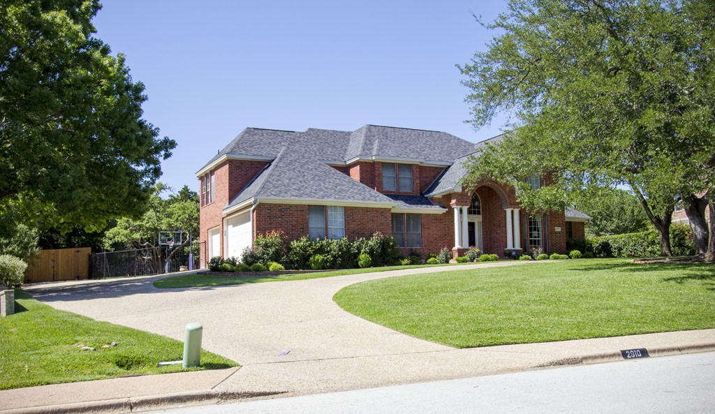 Red brick traditional in Barton Creek West. Example of typical homes in Barton Creek West neighborhood. 