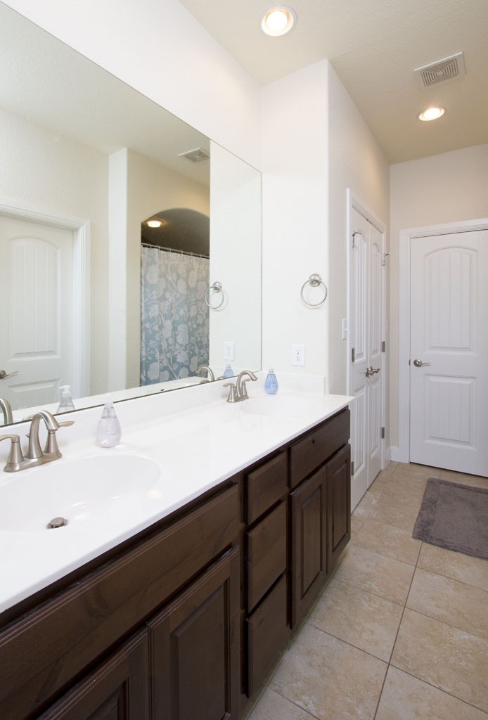Master Bath has double vanity, tile floors, and nickel fixtures.