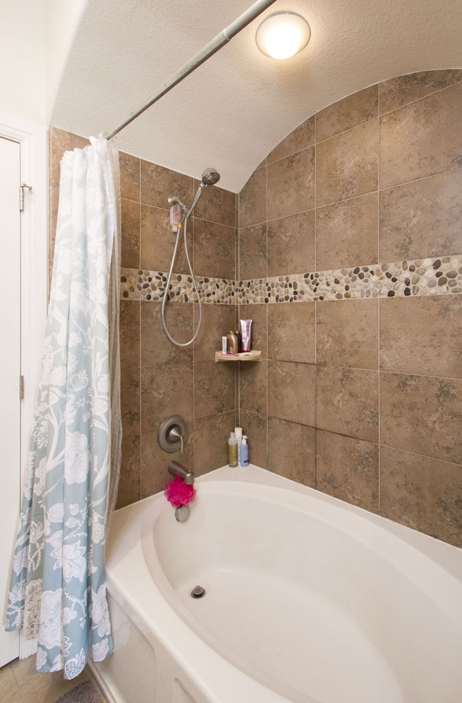 Garden tub and shower in master bath, with large tile. 