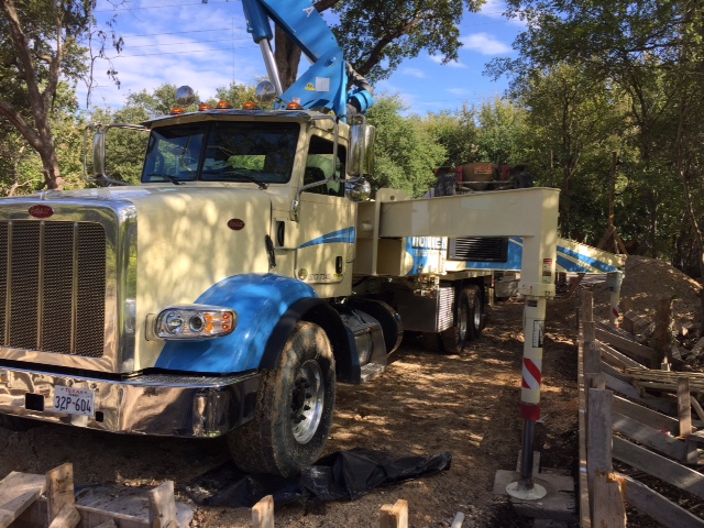 Modern farmhouse foundation pouring with pump truck set up.