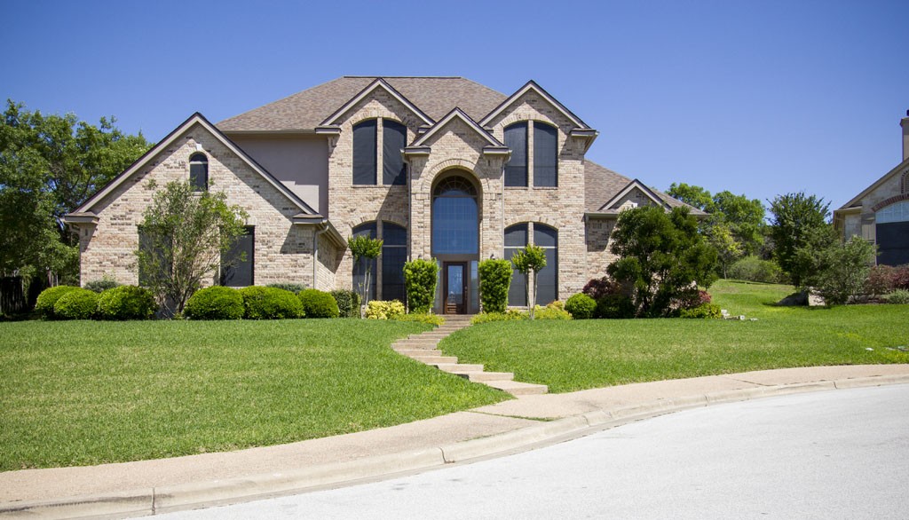 Senna Hills neighborhood home - brick traditional style with green lawn.