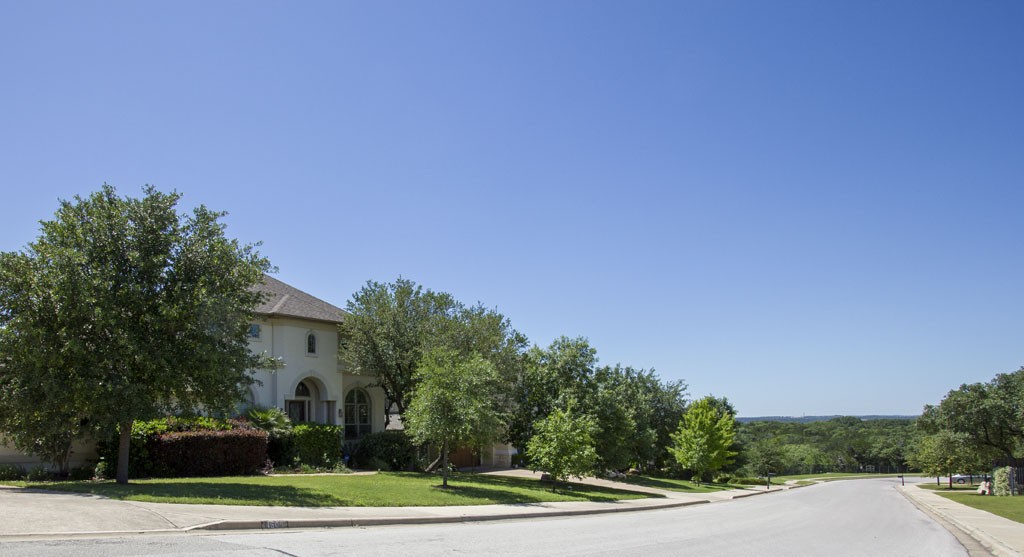 Senna Hills street scene with gently sloping streets and hill country views.