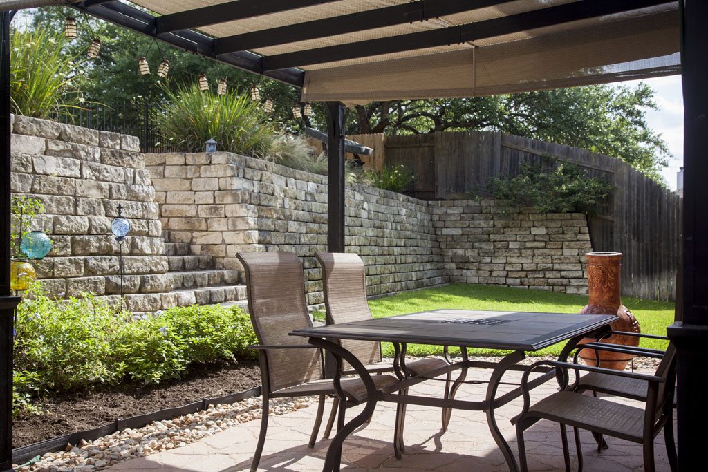12835 Majestic Oaks Dr. Stone patio for outdoor dining under covered awning. 