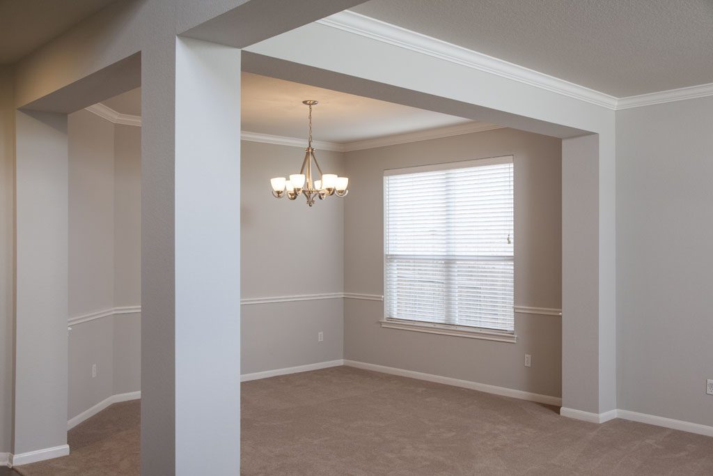 Columns define the formal dining space, enhanced by crown molding and chair rail trim.