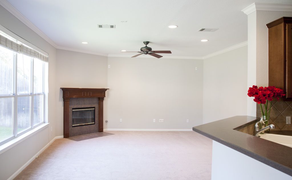 12835 Majestic Oaks Dr - Family room centers on traditional fireplace with wood mantle. 