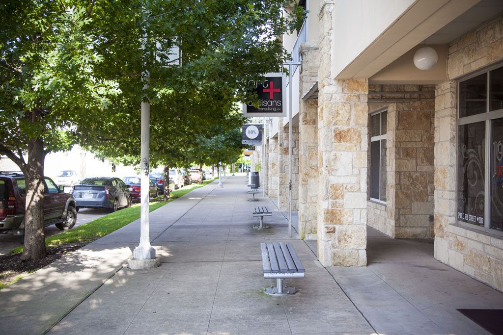 Sidewalk view of store-fronts at Pedernales Condo in central East Austin. 