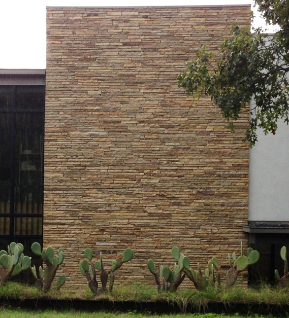 Stone wall of narrow horizontal lines gives modern, earthy style.