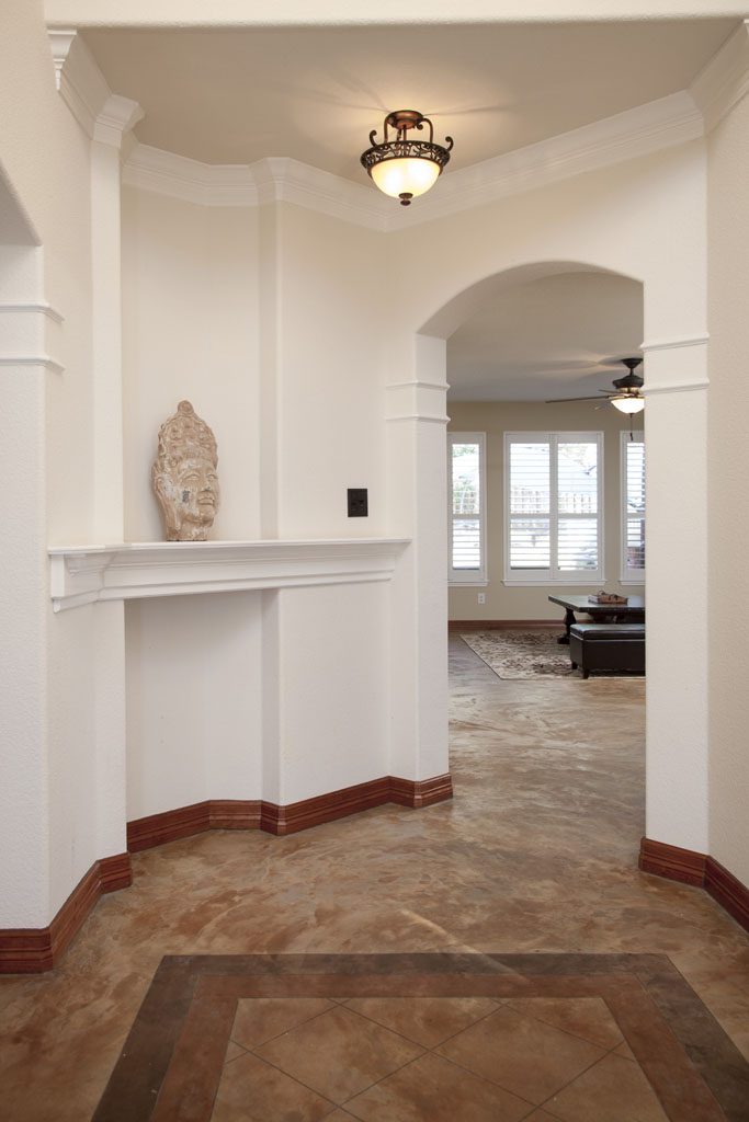 View of entry with concrete floors, white walls, land art niche.