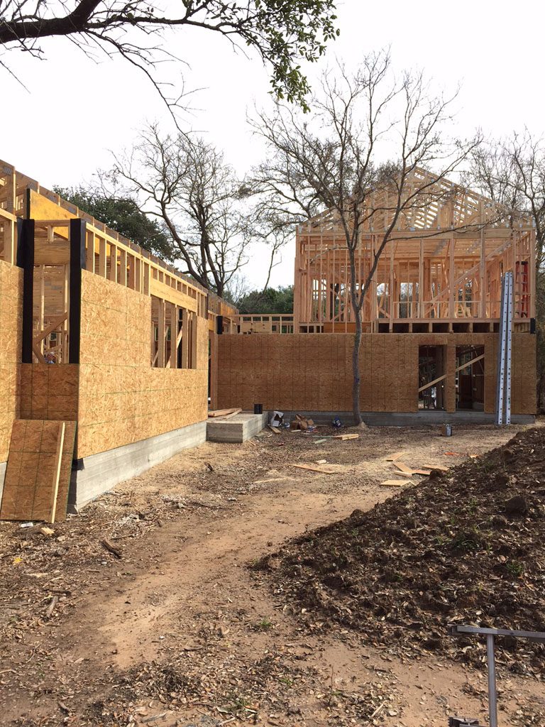 House under construction showing sheathing applied to exterior walls. 