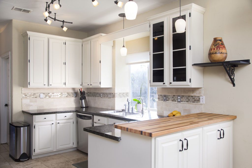 Stylish kitchen with modern lighting, butcher block countertop in Westlake home.