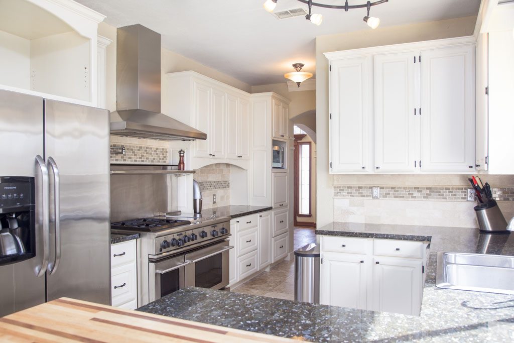 Updated kitchen with granite, stainless appliances and commercial range.