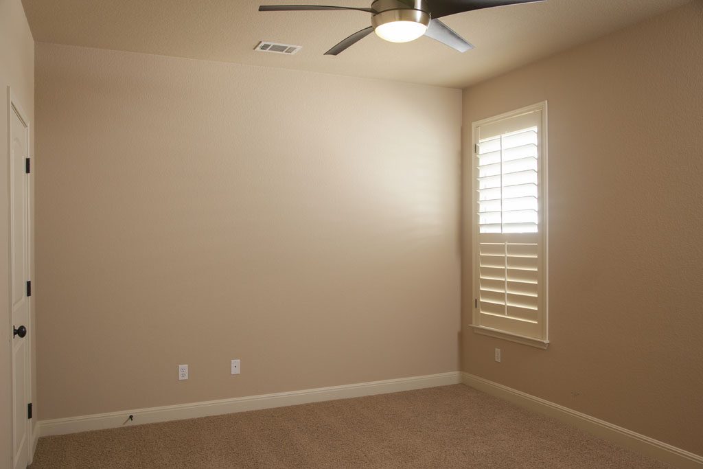 Bedroom #2 showing carpet floor, fan, and ceiling fan.