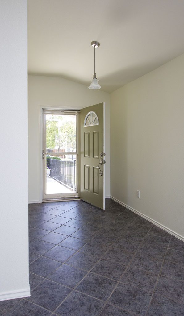 View of entry showing tile floors, high ceilings. 