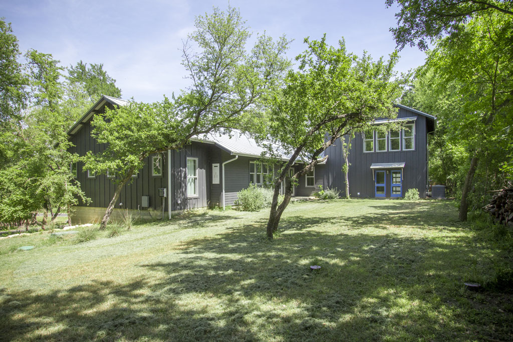Backyard of contemporary farmhouse in Austin Lake Hills neighborhood.
